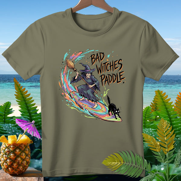 A witch on a surfboard with a black cat and "Bad Witches Paddle" text.
