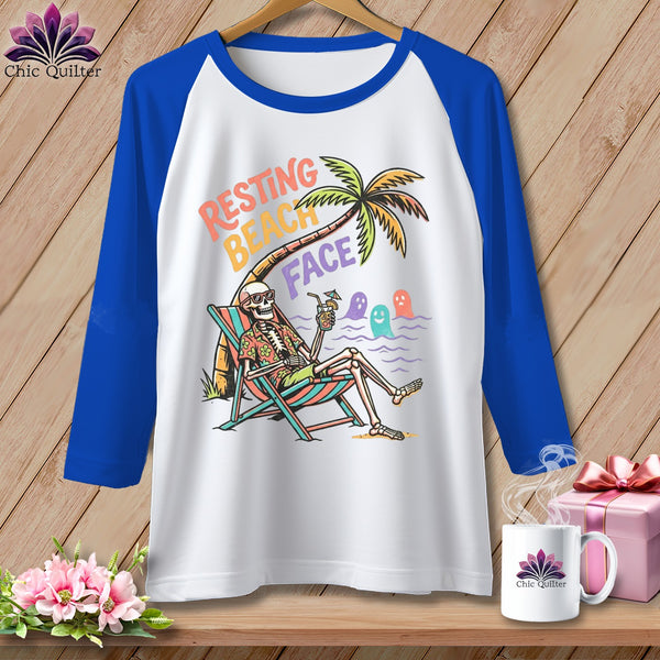 Raglan t-shirt with skeleton lounging on beach with "Resting Beach Face" text.