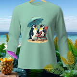 Two penguins on a beach under an umbrella, one playing guitar, with a pineapple and tropical plants.