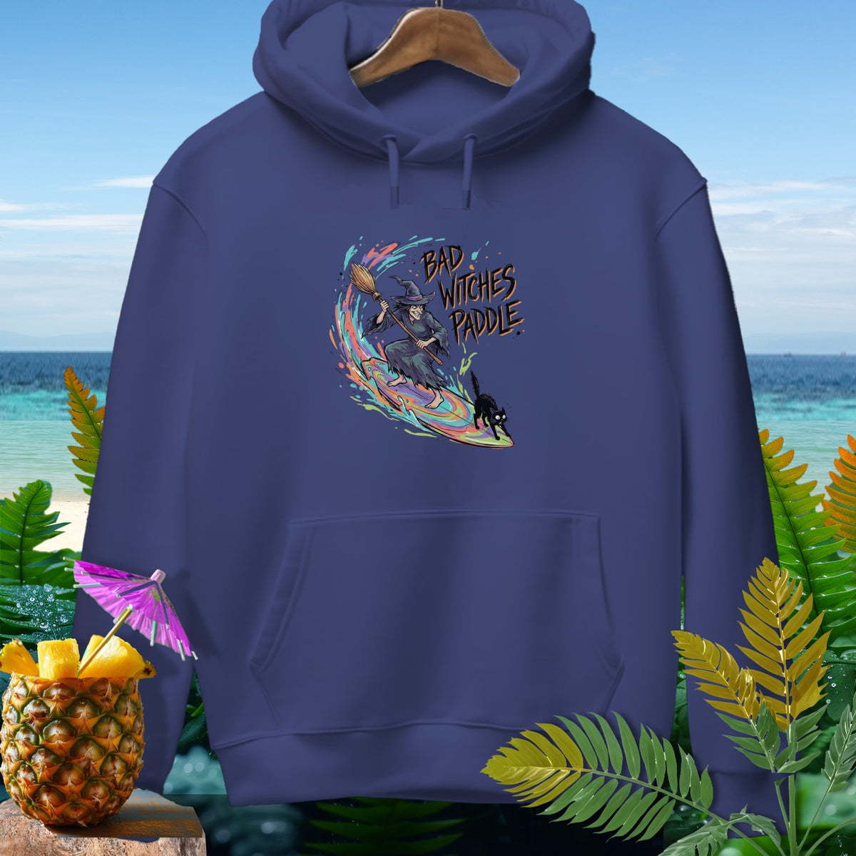 Navy hoodie with "Bad Witches Paddle" graphic of witch surfing with black cat.