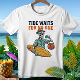 White t-shirt with skeleton holding surfboard and pumpkin candy bucket, text 