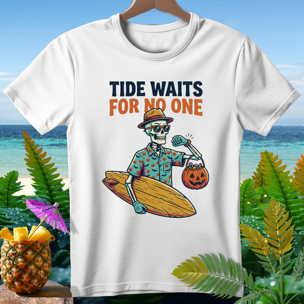 White t-shirt with skeleton holding surfboard and pumpkin candy bucket, text "TIDE WAITS FOR NO ONE".