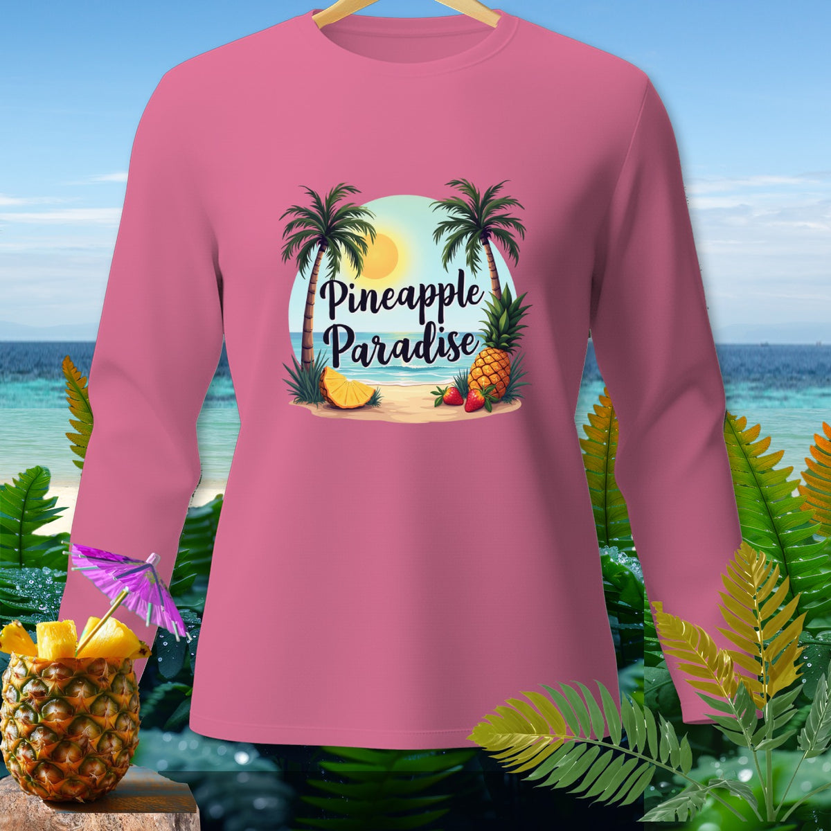Pink long-sleeve shirt with "Pineapple Paradise" text and beach graphic.