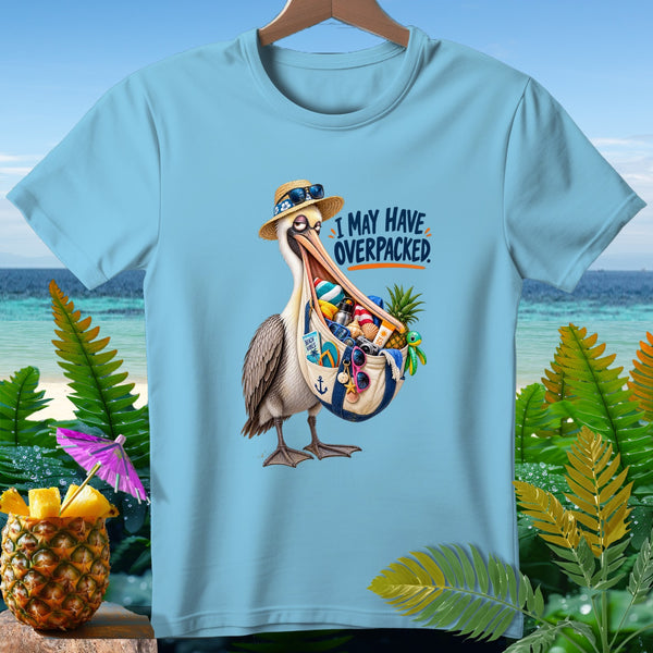 Light blue t-shirt with cartoon pelican on beach graphic that reads "I MAY HAVE OVERPACKED."