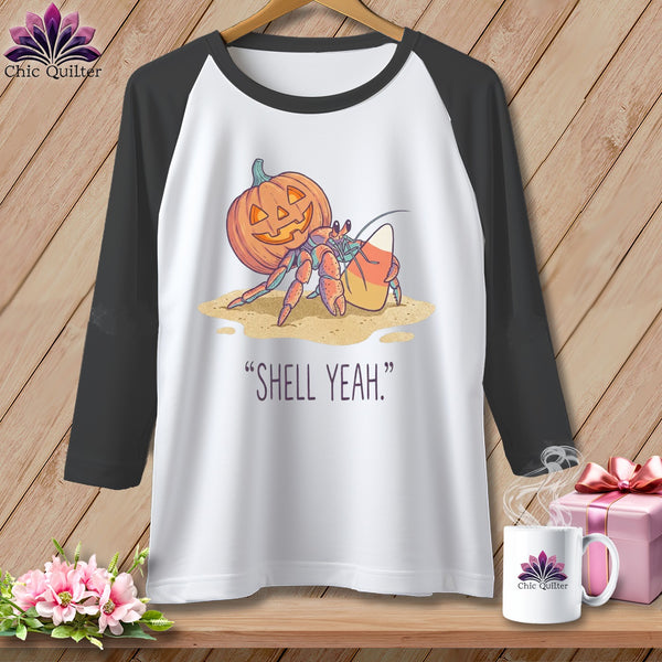 Hermit crab with pumpkin and candy corn on sand, reads "SHELL YEAH."