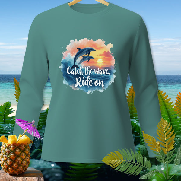 Teal long-sleeve shirt with two dolphins jumping out of waves at sunset.