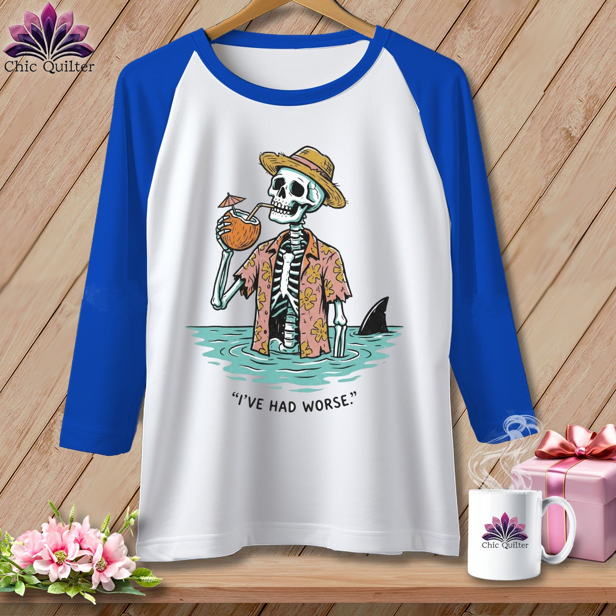 Raglan sleeve shirt with skeleton in Hawaiian shirt and hat drinking from coconut, shark fin visible.