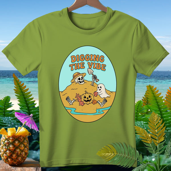 Green t-shirt with oval graphic: skeleton, ghost, pumpkin, "Digging the Vibe".