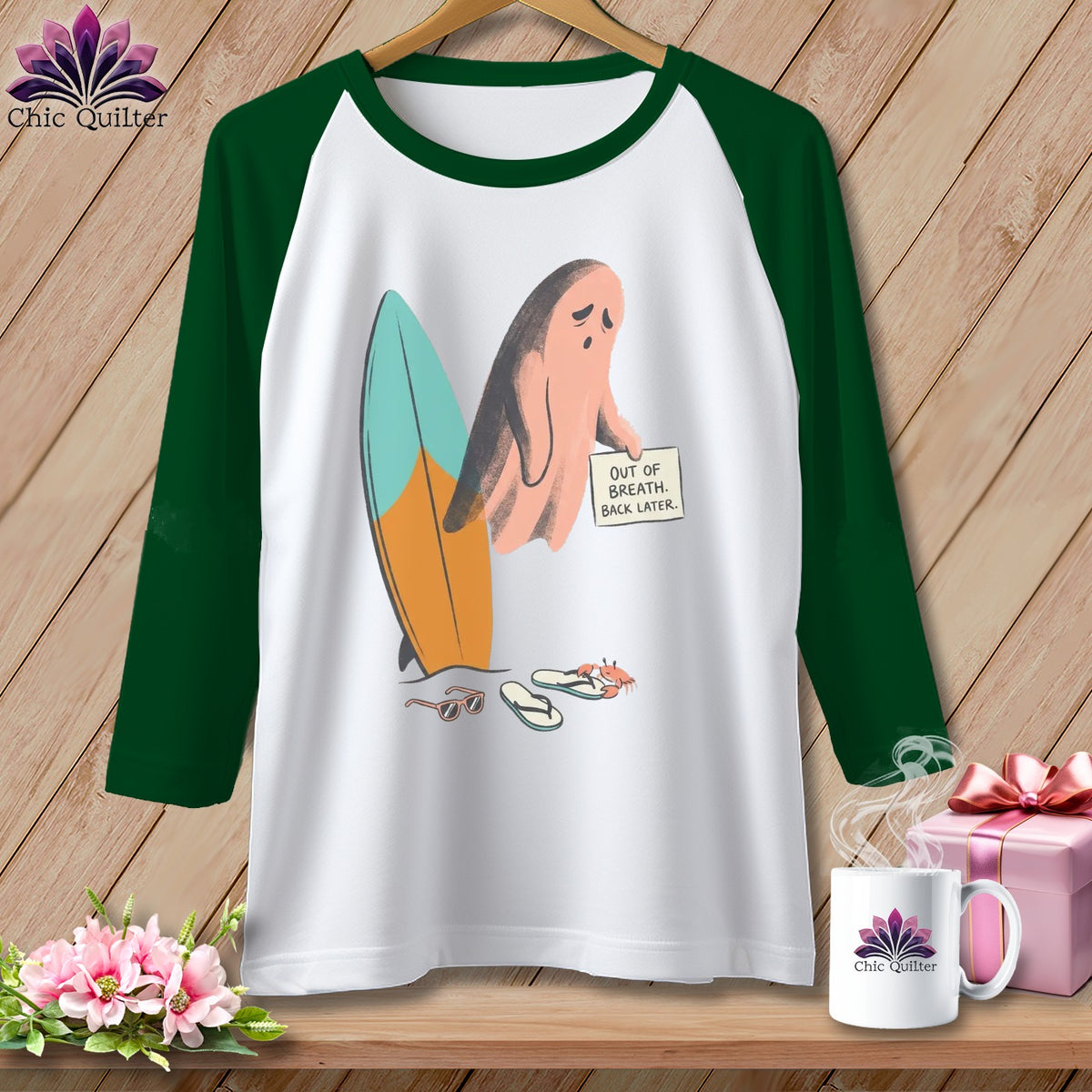 Raglan shirt with pink ghost, surfboard, sunglasses, flip-flops, and text.