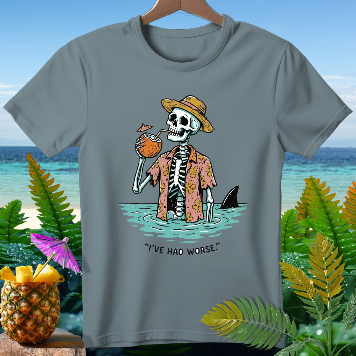 Skeleton in Hawaiian shirt drinks coconut, with shark fin and text "I'VE HAD WORSE."