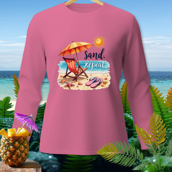 Pink long-sleeve shirt with "Sand. Repeat" beach graphic.
