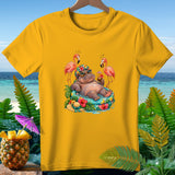 Yellow t-shirt with a graphic of a hippo relaxing with flamingos and tropical drinks.