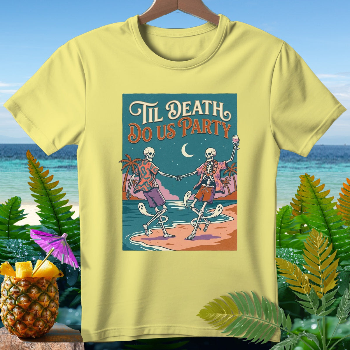Yellow t-shirt with "Til Death Do Us Party" and skeletons dancing on a beach.