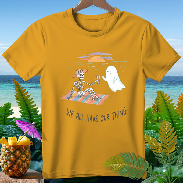 Skeleton wearing a hat on a beach with a ghost, text "We all have our thing."