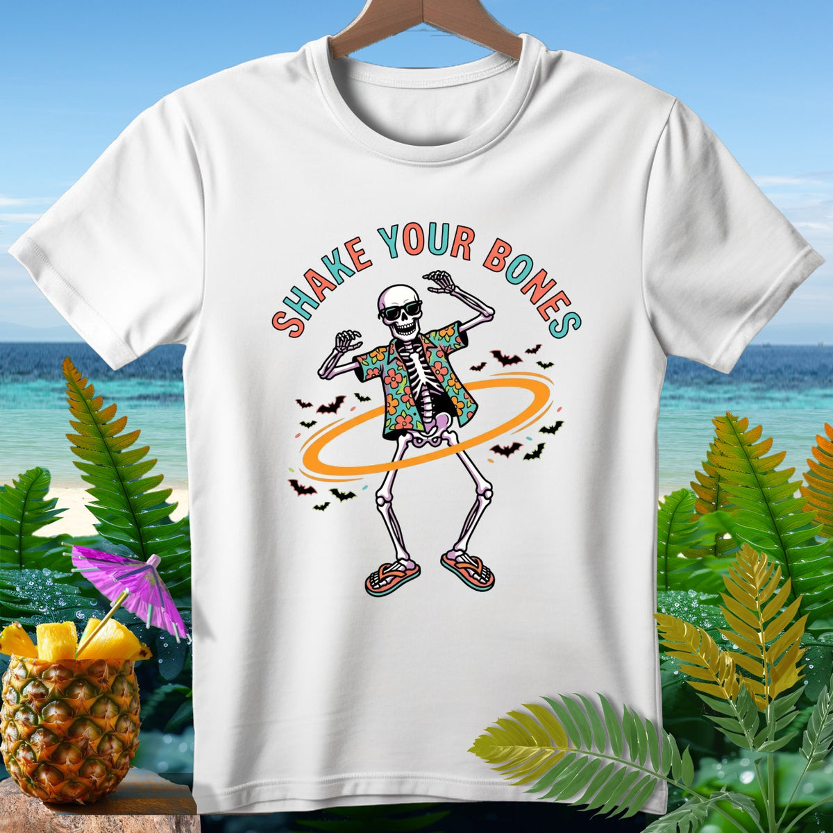 White t-shirt with a dancing skeleton graphic and the text "SHAKE YOUR BONES".