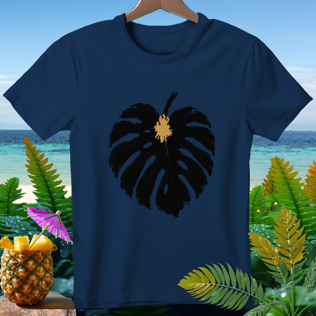 Navy t-shirt with black monstera leaf graphic, tropical background.