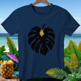 Navy t-shirt with black monstera leaf graphic, tropical background.