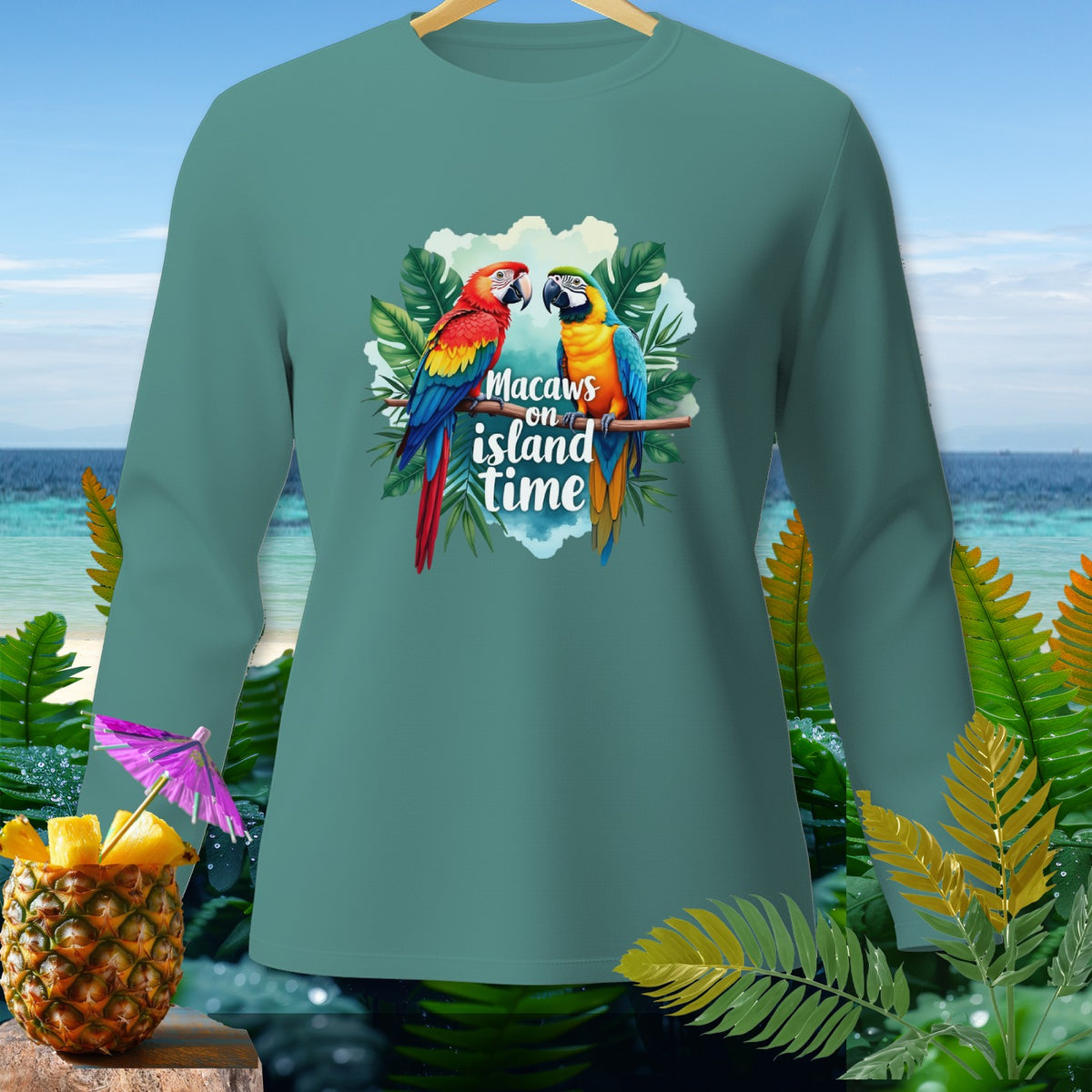 Teal long-sleeve shirt with two macaws and "Macaws on island time" text.
