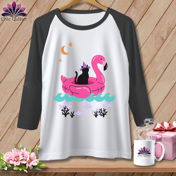 Black cat wearing witch hat on pink flamingo float with moon and stars.