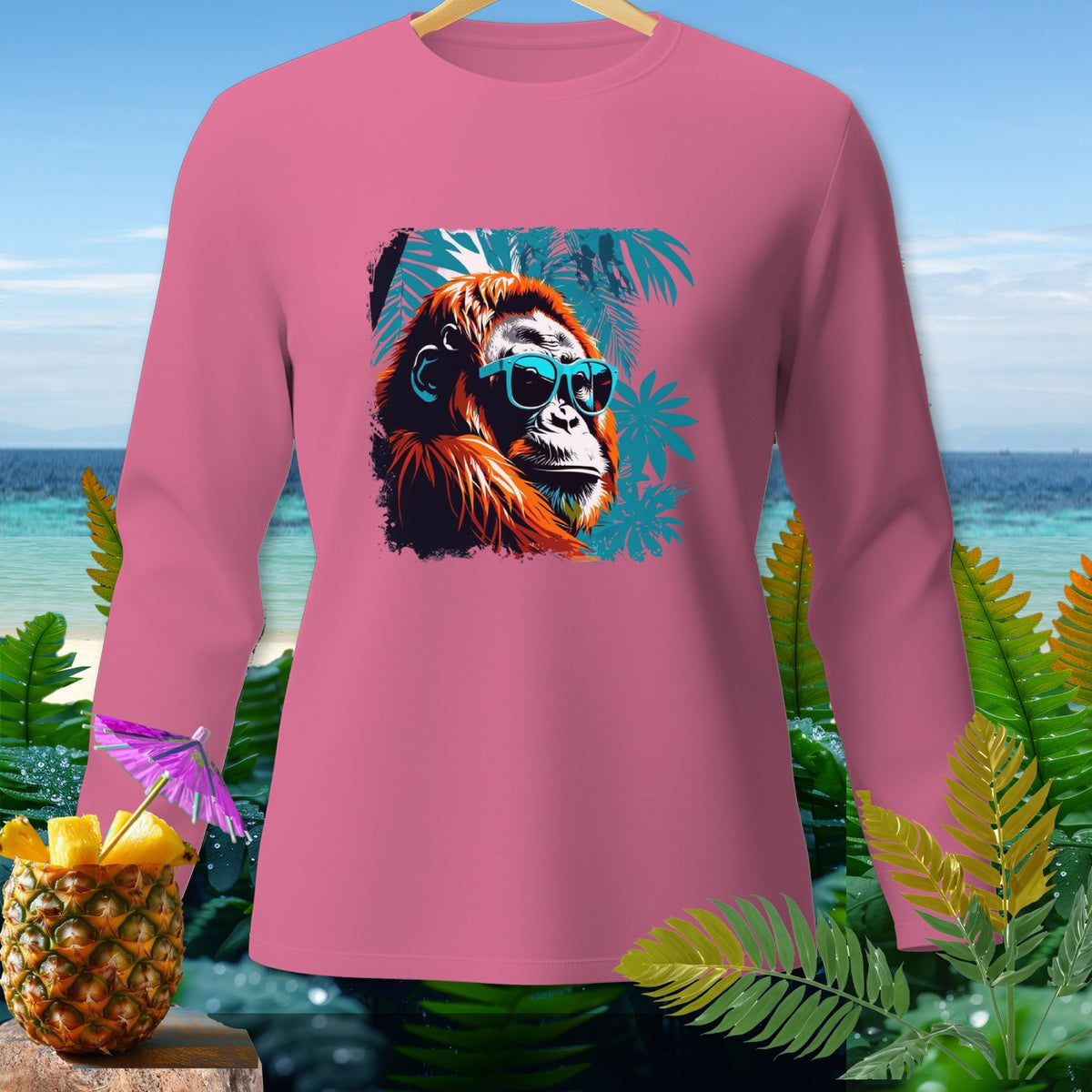 Pink long-sleeve shirt with orangutan wearing sunglasses and palm fronds graphic.