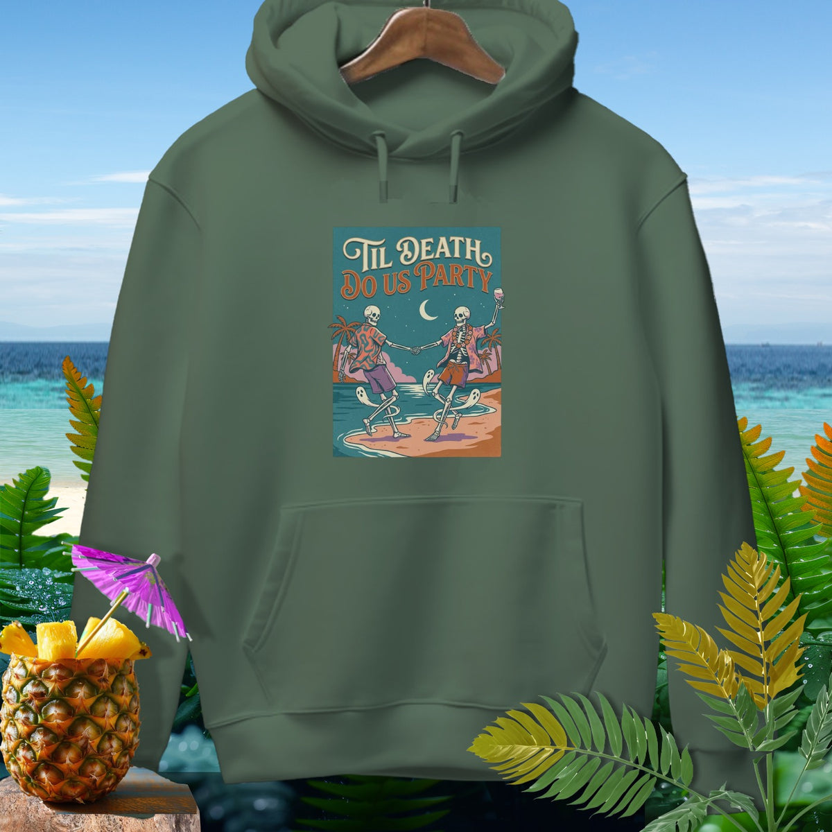 Green hoodie with "Til Death Do Us Party" graphic of dancing skeletons on a beach.