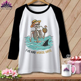 White baseball tee with skeleton in water, shark fin, and text 