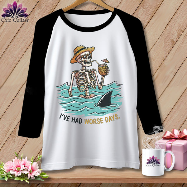 White baseball tee with skeleton in water, shark fin, and text "I'VE HAD WORSE DAYS."