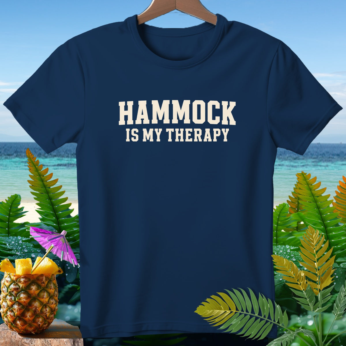 Navy t-shirt with "HAMMOCK IS MY THERAPY" text, tropical background.