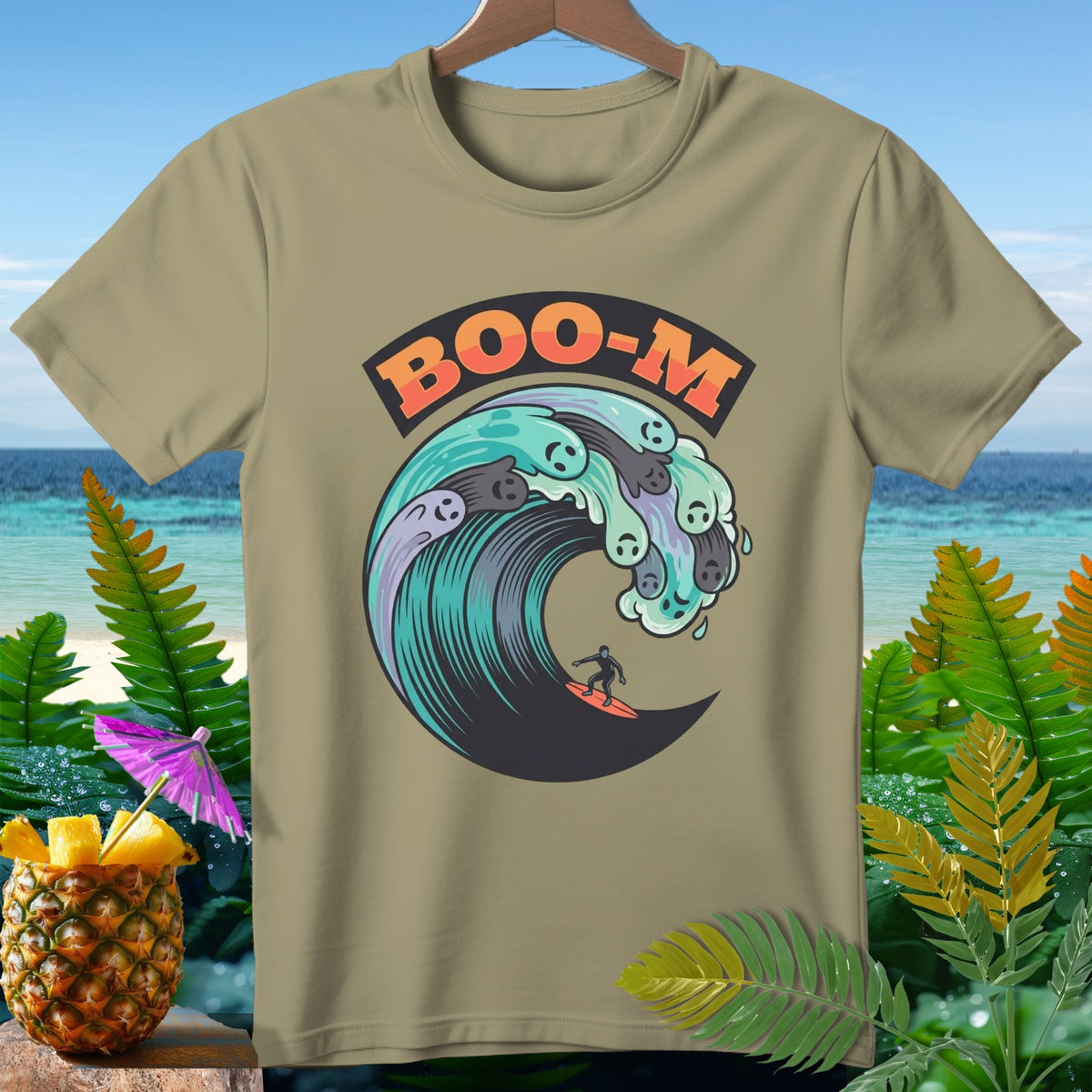 Khaki t-shirt with "BOO-M" text above a surfer on a wave with ghost faces.