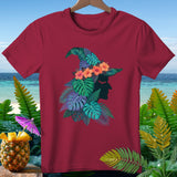Maroon t-shirt featuring a witch's hat adorned with tropical leaves and flowers.