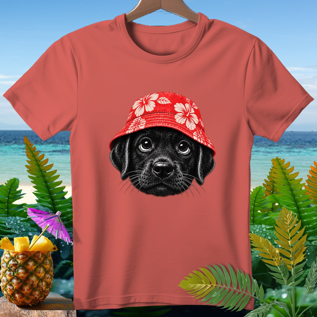 Coral t-shirt with a black puppy wearing a red floral bucket hat